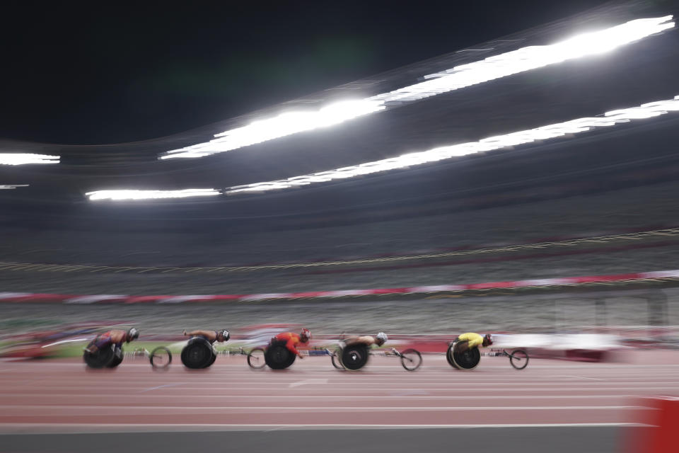 Athletes compete during men's T54 5000m heat at Tokyo 2020 Paralympic Games, Friday, Aug. 27, 2021, in Tokyo, Japan. Paralympic Games begins on Monday, May 20, 2024 and features three Paralympic athletes alone in an empty stadium with the slogan: “Il ne me manque rien, sauf vous” (I’m not missing anything, except you). (AP Photo/Eugene Hoshiko, File)