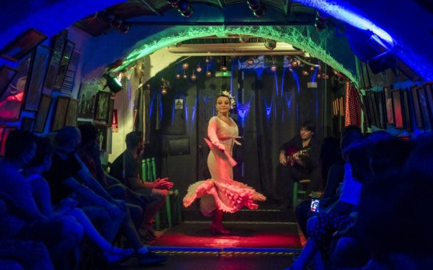 A dancer performs behind plastic as a protection measure. CREDIT: CARLOS GIL/GETTY - CARLOS GIL/GETTY