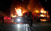 Aug 23, 2020; Kenosha, WI, USA; People gather as a city truck is on fire outside the Kenosha County Courthouse in Kenosha on Sunday, Aug. 23, 2020. Kenosha police shot a man Sunday evening, setting off unrest in the city after a video appeared to show the officer firing several shots at close range into the man's back. Mandatory Credit: Mike De Sisti/Milwaukee Journal Sentinel via USA TODAY NETWORK/Sipa USA