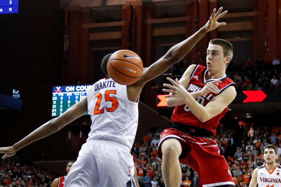 Louisville Cardinals guard Ryan McMahon (30) passes the ball as Virginia Cavaliers forward Mamadi Diakite (25) defends in the first half at John Paul Jones Arena in Charlottesville, Virginia, on Wednesday, Jan. 31, 2018.