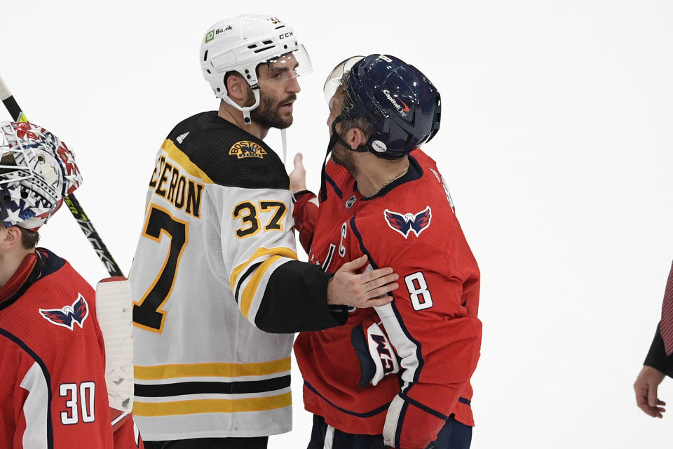 Boston Bruins center Patrice Bergeron (37) and Washington Capitals left wing Alex Ovechkin (8) meet in the handshake line after Game 5 of an NHL hockey Stanley Cup first-round playoff series, Sunday, May 23, 2021, in Washington. The Bruins won 3-1. (AP Photo/Nick Wass)