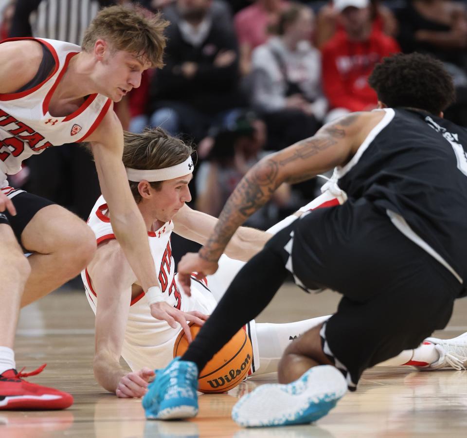 Utah Utes center Branden Carlson (35) and Hawaii Warriors forward Justin McKoy (1) fight for the ball at the Delta Center in Salt Lake City on Thursday, Nov. 30, 2023. | Jeffrey D. Allred, Deseret News