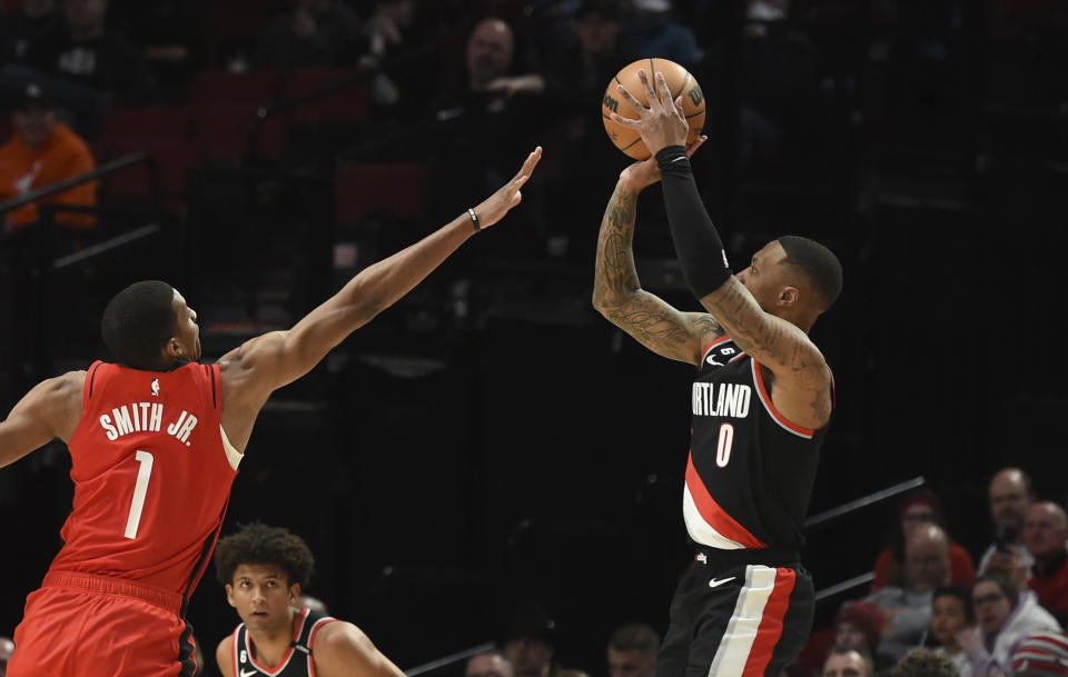 Portland Trail Blazers guard Damian Lillard, right, hits a basket over Houston Rockets forward Jabari Smith Jr., left, during the first half of an NBA basketball game in Portland, Ore., Sunday, Feb. 26, 2023. (AP Photo/Steve Dykes)