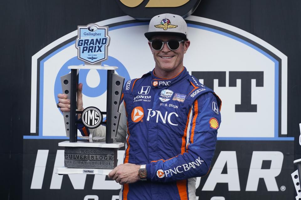 Scott Dixon, of New Zealand, holds the trophy after winning an IndyCar Indianapolis GP auto race at Indianapolis Motor Speedway, Saturday, Aug. 12, 2023, in Indianapolis. (AP Photo/Darron Cummings)