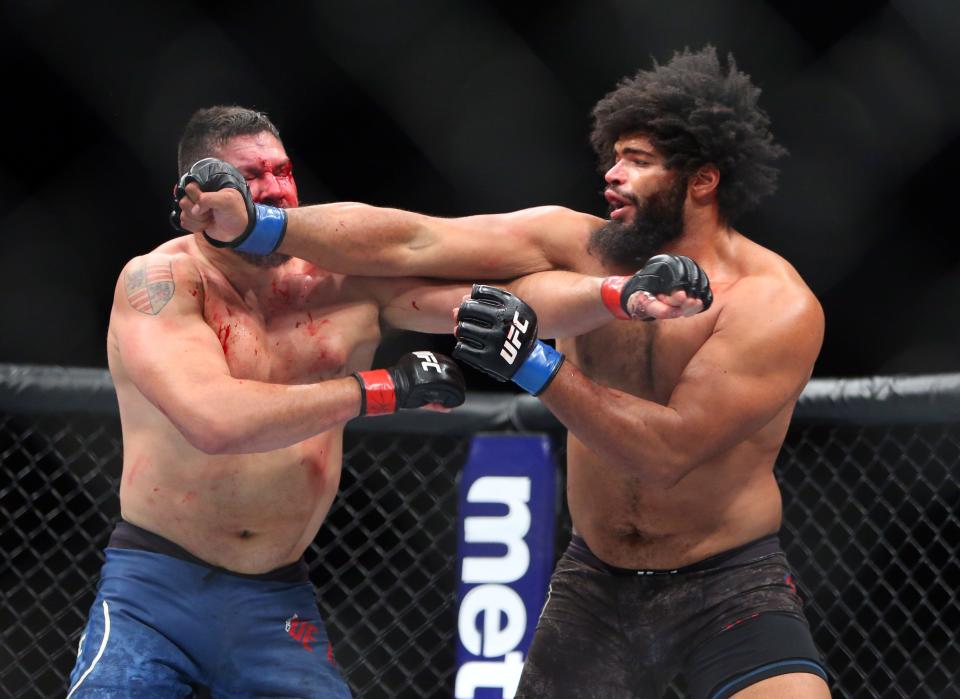 Heavyweight Juan Adams (right) delivers a blow to the bloodied face of Chris De La Rocha during the opening bout on Saturday night.