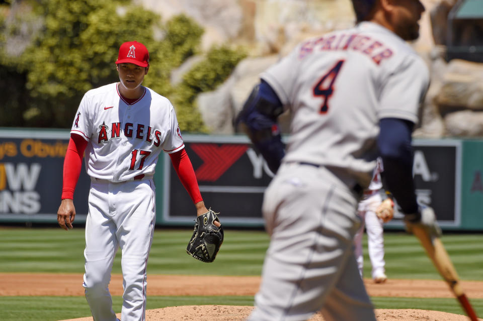 Los Angeles Angels pitcher Shohei Ohtani, of Japan, stands at left after walking Houston Astros' George Springer with the bases loaded during the second inning of a baseball game Sunday, Aug. 2, 2020, in Anaheim, Calif. (AP Photo/Mark J. Terrill)