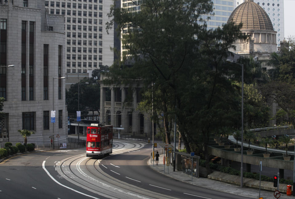 In this Jan. 11, 2013 photo, a tram runs in Central in downtown Hong Kong. Hop aboard the century-old tram system for an old-fashioned ride through the neighborhoods along the length of the northern edge of the island. (AP Photo/Kin Cheung)