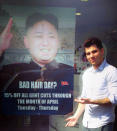 This undated photo provided by M&M Hair Academy in South Ealing, west London, shows barber Karim Nabbach standing next to a poster poking fun at North Korean leader Kim Jong-un unusual hairstyle. North Korean diplomats have asked the British government take action against a London hair salon’s poster poking fun at distinctively coiffured leader Kim Jong Un. The Foreign Office said Wednesday it had received a letter from the country’s embassy objecting to the poster, and was considering its response. The Evening Standard newspaper reported that the letter urged Britain to take “necessary action to stop the provocation.” Staff at M&M Hair Academy say they were visited by diplomats from the nearby embassy after putting up a poster featuring a picture of Kim - who sports a distinctive undercut - and the slogan "Bad Hair Day?" Police say they spoke to both parties and determined no crime had been committed. The embassy didn’t immediately respond to a request for comment. (AP Photo/M&M Hair Academy)