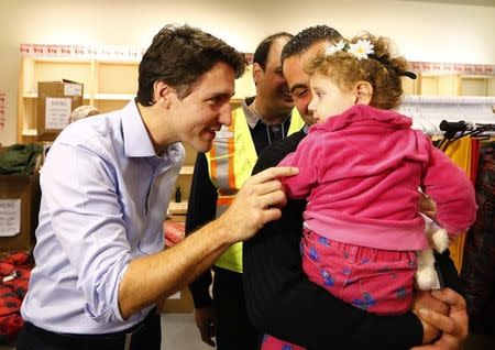 Syrian refugees are greeted by Canada's Prime Minister Justin Trudeau (L) on their arrival from Beirut at the Toronto Pearson International Airport in Mississauga, Ontario, Canada December 11, 2015. REUTERS/Mark Blinch