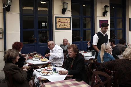 People eat at a restaurant at central Monastiraki square in Athens in this November 11, 2014 file photo. REUTERS/Alkis Konstantinidis/Files