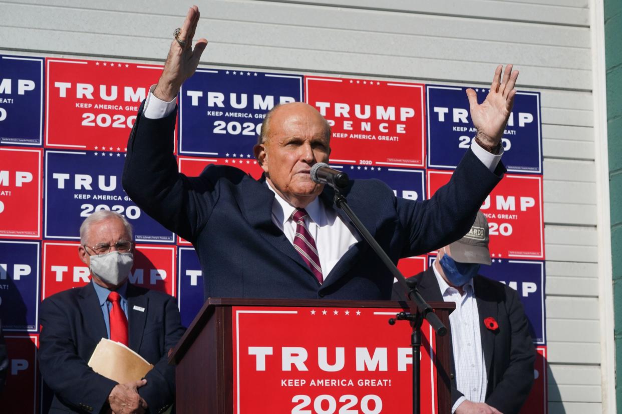  Rudy Giuliani, speaks at a news conference in the parking lot of a landscaping company in Philadelphia in November 2020 (AFP via Getty Images)