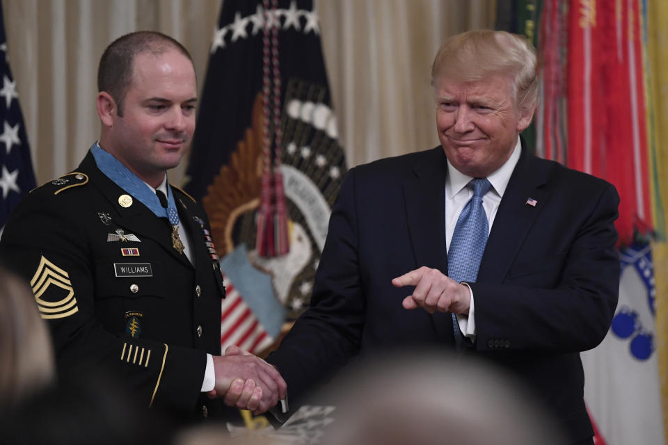 President Donald Trump, right, shakes hands with U.S. Army Master Sgt. Matthew Williams, left, currently assigned to the 3rd Special Forces Group, after presenting him with the Medal of Honor during a ceremony in the East Room of the White House in Washington, Wednesday, Oct. 30, 2019. (AP Photo/Susan Walsh)