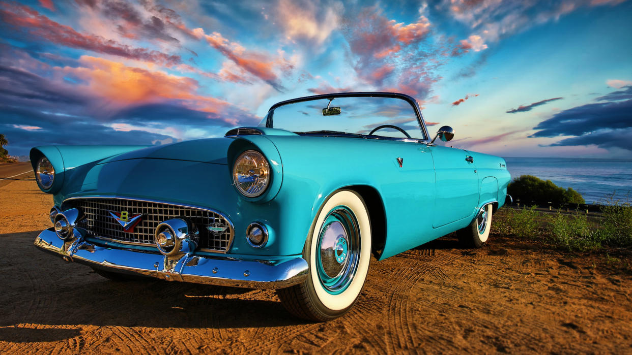 This is a close up photo of a blue ford Thunderbird on a bluff overlooking the ocean in San Diego California (This is a close up photo of a blue ford Thunderbird on a bluff overlooking the ocean in San Diego California, ASCII, 109 components, 109 byte.