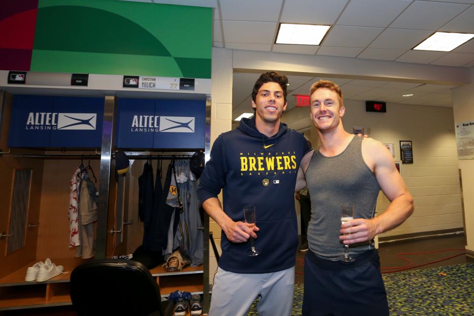 Sep 22, 2023; Miami, Florida, USA; Milwaukee Brewers left fielder Christian Yelich (left) and left fielder Mark Canha (right) celebrate clinching a MLB postseason berth after the game against the Miami Marlins at loanDepot Park. Mandatory Credit: Sam Navarro-USA TODAY Sports