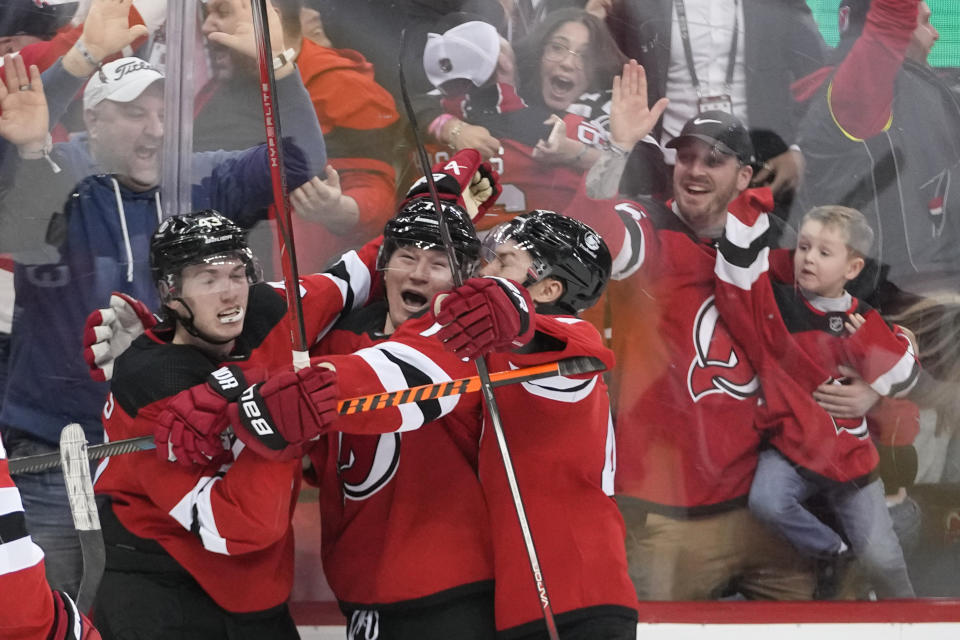 New Jersey Devils right wing Tyler Toffoli, center, celebrates scoring a hat trick and the winning goal during overtime of an NHL hockey game against the Vegas Golden Knights, Monday, Jan. 22, 2024, in Newark, N.J. The Devils won 6-5. (AP Photo/Mary Altaffer)