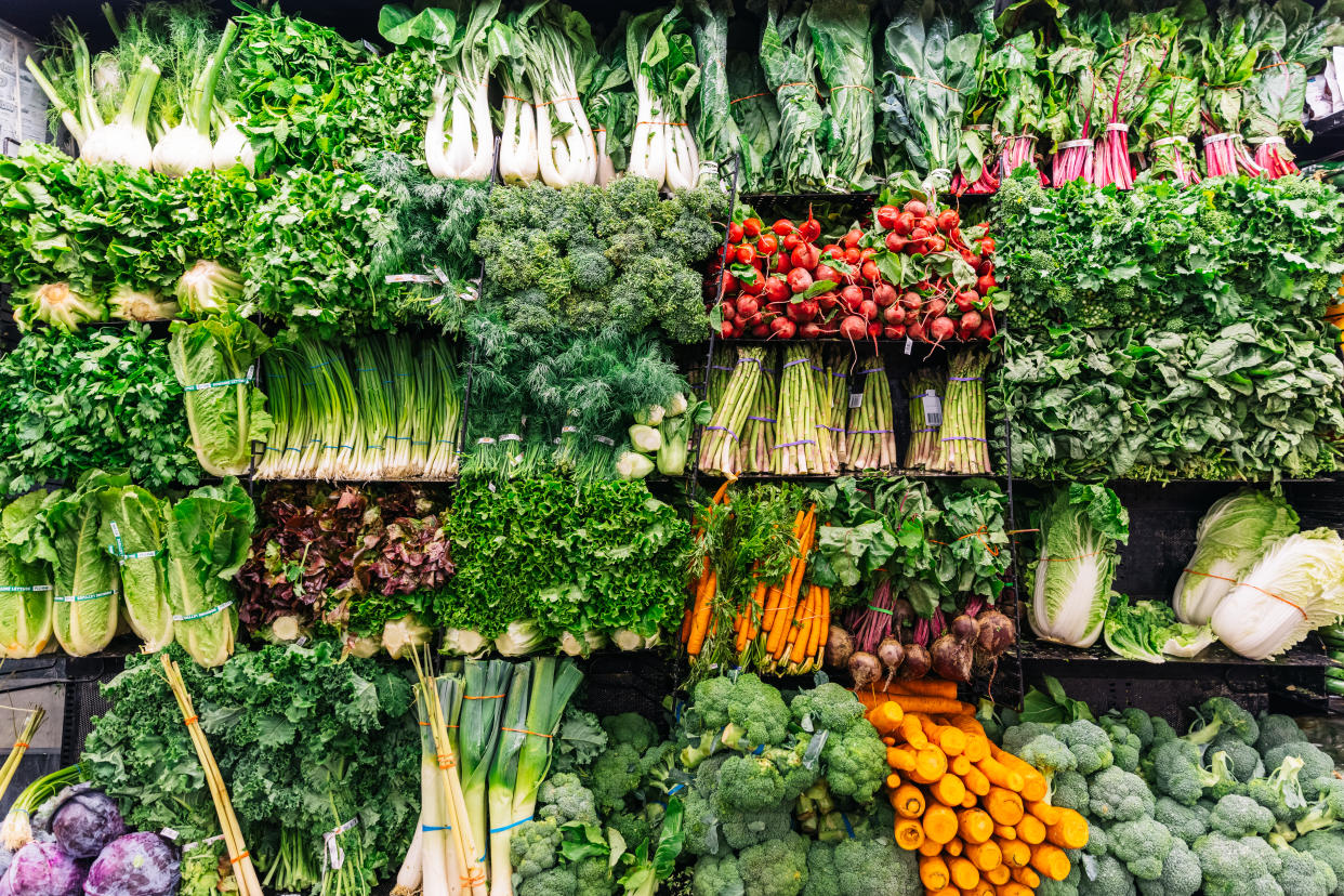 vegan food fruit and vegetables on a stand in a supermarket