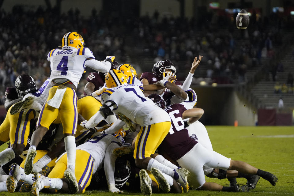 Texas A&M quarterback Kellen Mond (11) has the ball knocked out of his hands by LSU on a fourth-down play during the second quarter of an NCAA college football game Saturday, Nov. 28, 2020, in College Station, Texas. (AP Photo/Sam Craft)