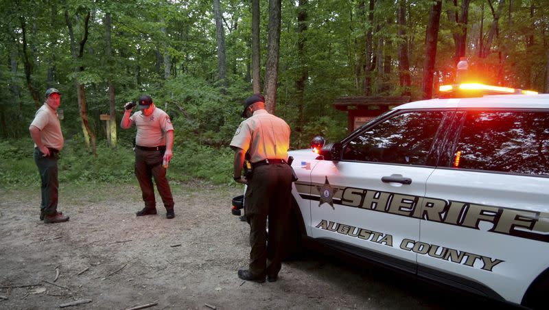 Authorities secure the entrance to Mine Bank Trail, an access point to the rescue operation along the Blue Ridge Parkway where a Cessna Citation crashed over mountainous terrain near Montebello, Va., Sunday, June 4, 2023.