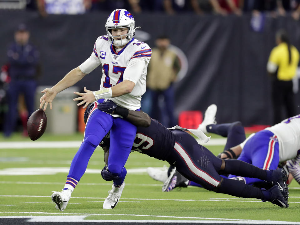 Buffalo Bills quarterback Josh Allen (17) fumbles the ball as he is hit by Houston Texans outside linebacker Whitney Mercilus during the second half of an NFL wild-card playoff football game Saturday, Jan. 4, 2020, in Houston. The Texans recovered the fumble. (AP Photo/Michael Wyke)