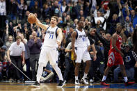 Dallas Mavericks forward Luka Doncic (77) celebrates after the Mavericks defeated the Houston Rockets 107-104 in an NBA basketball game, Saturday, Dec. 8, 2018, in Dallas. (AP Photo/Cooper Neill)