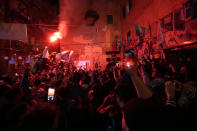 Napoli fans celebrates after Napoli's Victor Osimhen scored his side's first goal as they watch a screen live broadcasting Udinese Napoli Serie A soccer match, in Naples, Italy, Thursday, May 4, 2023. For the third time in five days, Napoli fans are hoping and preparing to celebrate the Italian league soccer title. (AP Photo/Andrew Medichini)