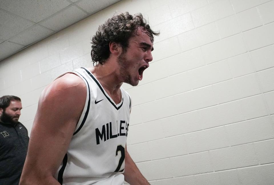 Noblesville Millers forward Luke Almodovar (2) yells in excitement while walking back to the loclkerooms after defeating the Carmel Greyhounds on Friday, Dec. 9, 2022 at Noblesville High School in Noblesville. Noblesville Millers defeated the Carmel Greyhounds, 45-42. 