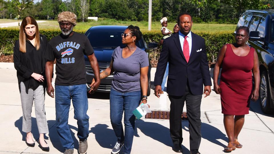 Crosley Green, second from left, walks into to Department of Corrections office in Orlando, Florida, holding the hand of his   fiancé, Katherine Spikes. They are flanked by his attorneys Jeane Thomas and Keith Harrison. Green turned himself into federal authorities on Monday after a 2018 court order granting him a new trial was overturned by the 11th Circuit Court of Appeals.  / Credit: Malcolm Denemark/Pool photo