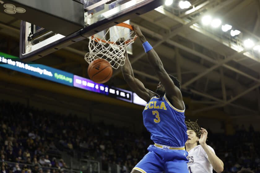 UCLA forward Adem Bona dunks against Washington during the first half of an NCAA college basketball.