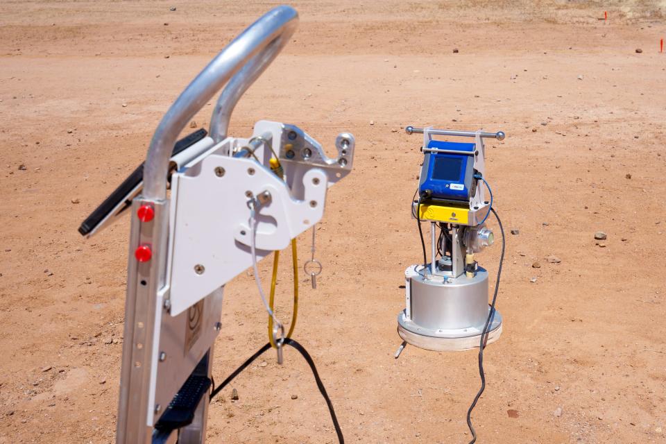 A portable institute wind erosion laboratory (PI-SWERL) sits on a piece of land that has been treated with enzyme-induced carbonate precipitation (ECIP) during a dust mitigation trial conducted by Researchers from ASU in Mesa, Arizona, on April 21, 2022. The PI-SWERL simulates wind conditions and measures the potential dust flux from a surface on which it is placed. PI-SWERL measurements will be used to understand how effective the ECIP crust is at mitigating dust pollution.