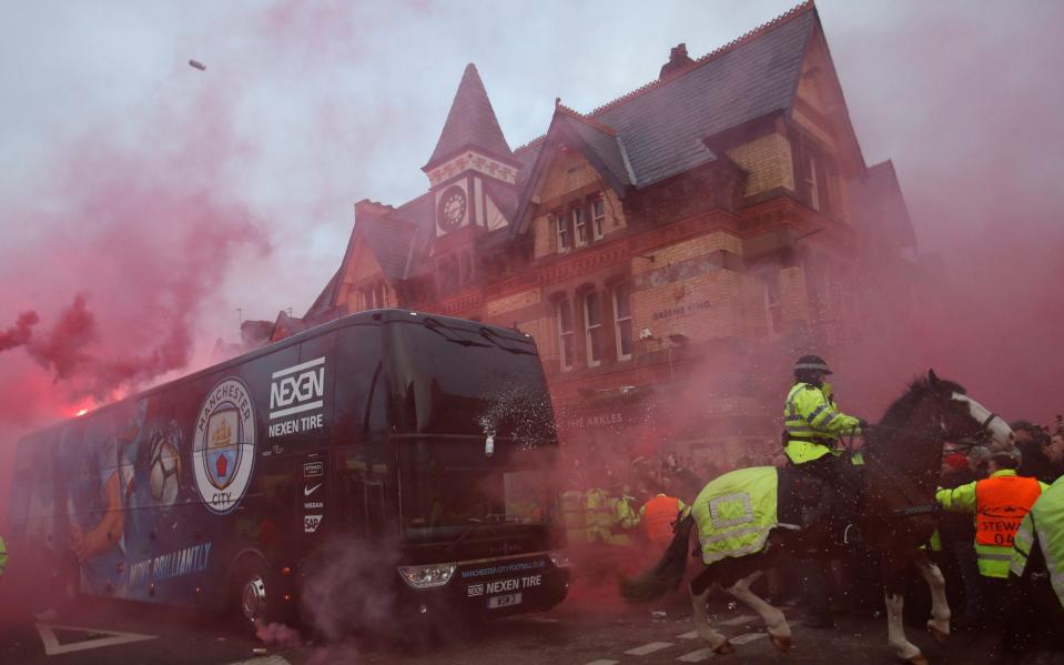 Liverpool fans set off flares and throw missiles at the Manchester City team bus - Action Images via Reuters/Carl Recine