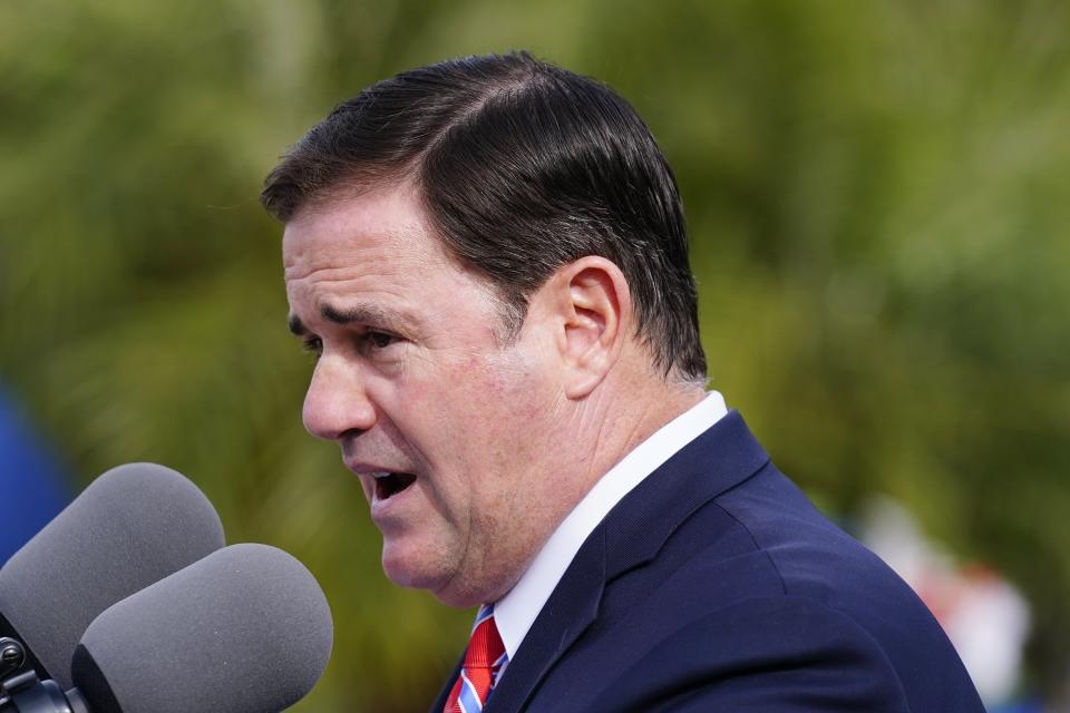 FILE - Arizona Republican Gov. Doug Ducey speaks at a ceremony on Dec. 7, 2021, in Phoenix. Ducey and the GOP leaders of the state House and Senate are urging the state Supreme Court to overrule lower court judges and block three voter initiatives from the ballot. (AP Photo/Ross D. Franklin, File)