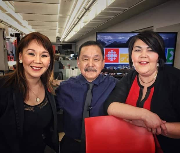 Allakariallak, left, news reader Kowisa Arlooktoo, centre, and producer Pauline Pemik at CBC's Iqaluit bureau. 'Our struggles … are very different,' Allakariallak said of the experiences of Inuit and non-Inuit colleagues.