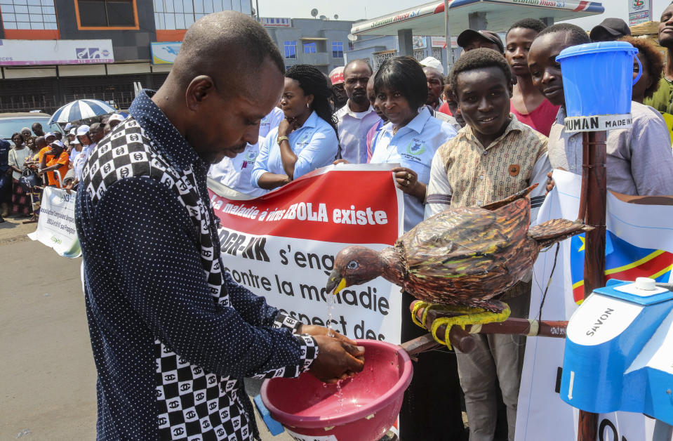 A participant washes his hands in a water dispenser shaped as a bird, during a march to raise awareness about Ebola, in the city of Goma, in eastern Congo Thursday, Aug. 22, 2019. Hundreds gathered in Goma to support Ebola response teams that have seen increasing attacks and resistance among communities where Ebola continues to spread after killing at least 1,800 people in the year since the outbreak began. (AP Photo/Justin Kabumba)