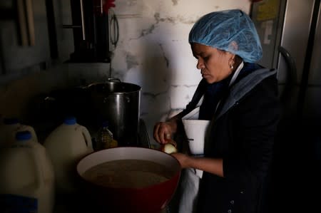 Salvadoran migrant Elizabeth Rodriguez, who is waiting for her court hearing for asylum seekers that returned to Mexico to await their legal proceedings under a new policy established by the U.S. government, cooks at a migrant shelter in Ciudad Juarez