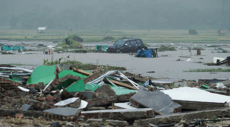 A car is seen among debris after the area was hit by a tsunami in Pandeglang, Banten province, Indonesia, December 23, 2018. REUTERS/Stringer