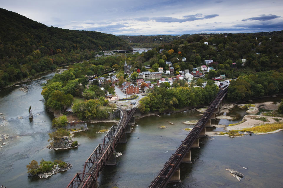 An aerial shot of Harpers Ferry that shows off the two bridges, charming buildings, and the surrounding green areas.