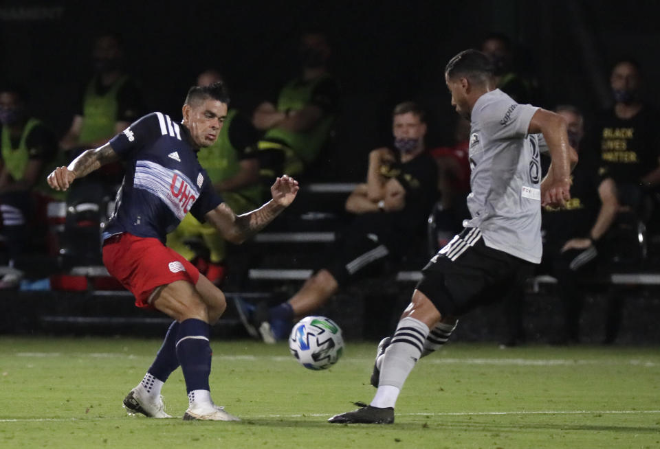 New England Revolution forward Gustavo Bou, left, competes for the ball with Montreal Impact midfielder Saphir Taider (8) during the first half of an MLS soccer match Thursday, July 9, 2020, in Kissimmee, Fla. (AP Photo/John Raoux)