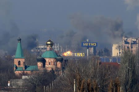 Smoke rises above an old terminal (L) and an administrative building of the Sergey Prokofiev International Airport after the recent shelling during fighting between pro-Russian separatists and Ukrainian government forces in Donetsk, eastern Ukraine, November 9, 2014. REUTERS/Maxim Zmeyev
