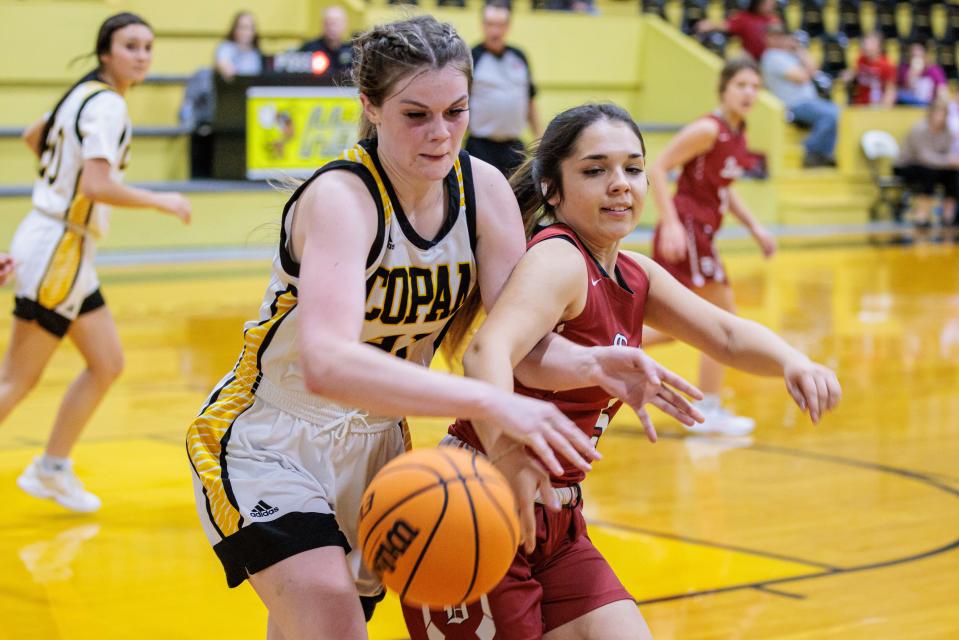 Copan's Skylar Odum and Dewey's Paola Lopez fight for the ball during action in December 2021.