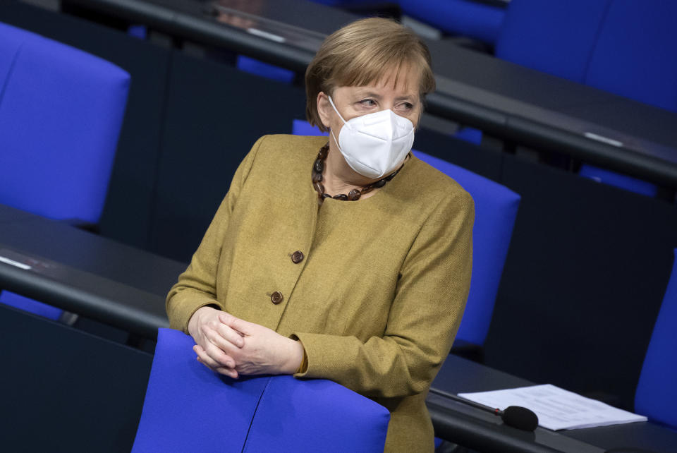 German Chancellor Angela Merkel attends a meeting of the German Federal Parliament, Bundestag, at the Reichstag building in Berlin, Germany, Thursday, Jan. 28, 2021. (Bernd von Jutrczenka/dpa via AP)