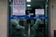 Medical workers stand by at a hospital in Daegu