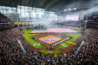 Smoke clears as the national anthem is played before the Houston Astros' season-opening baseball game against the Chicago White Sox on Thursday, March 30, 2023, in Houston. (Brett Coomer/Houston Chronicle via AP)