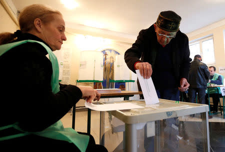 A man casts his ballot during the second round of parliamentary election in Tbilisi, Georgia, October 30, 2016. REUTERS/David Mdzinarishvili