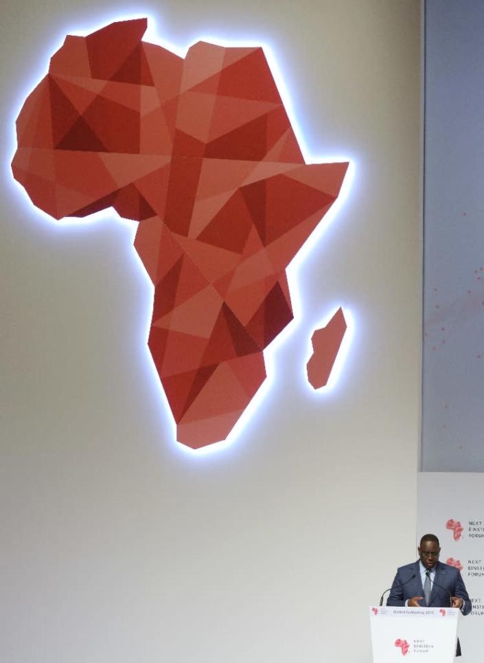Senegal President Macky Sall (R) delivers a speech under a map of Africa in Dakar during the opening of the "Next Einstein Forum" (NEF) on March 8, 2016 (AFP Photo/Seyllou)