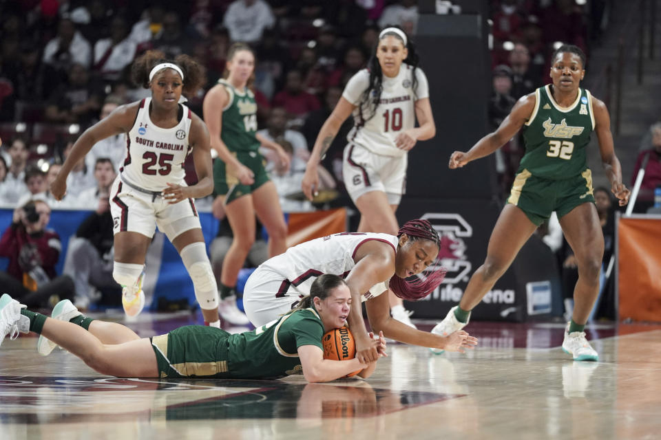 South Carolina forward Aliyah Boston, top, and South Florida guard Aerial Wilson battle for a loose ball during the first half in a second-round college basketball game in the NCAA Tournament, Sunday, March 19, 2023, in Columbia, S.C. (AP Photo/Sean Rayford)