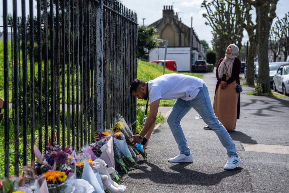 A man lays flowers outside Jacobs House tower block in Plaistow, east London (Getty Images)