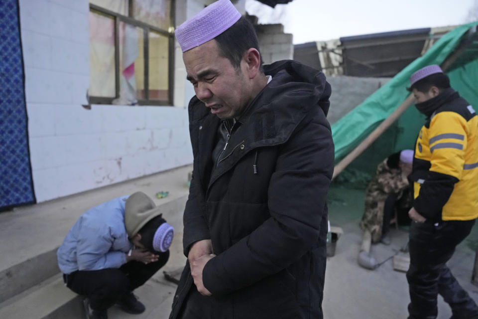 Ma Lianqiang grieves for his wife who was killed in the earthquake in Yangwa village near Dahejia town in northwestern China's Gansu province, Wednesday, Dec. 20, 2023. A strong overnight earthquake rattled a mountainous region of northwestern China, authorities said Tuesday, destroying homes, leaving residents out in a below-freezing winter night and killing many in the nation's deadliest quake in nine years. (AP Photo/Ng Han Guan)