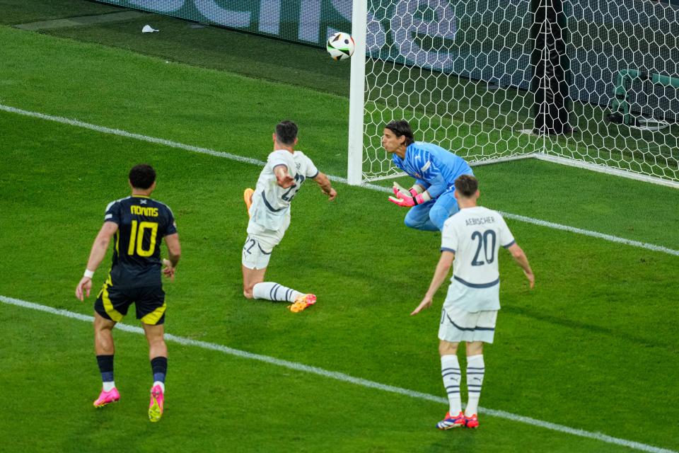 Fabian Schar deflects McTominay’s shot into the goal (AP)