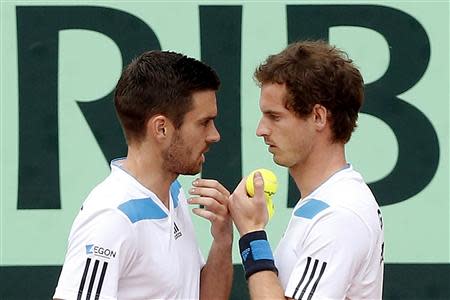 Britain's Andy Murray (R) chats with teammate Colin Fleming during their Davis Cup quarter-final doubles tennis match against Italy's Fabio Fognini and Simone Bolelli in Naples April 5, 2014. REUTERS/Alessandro Bianchi