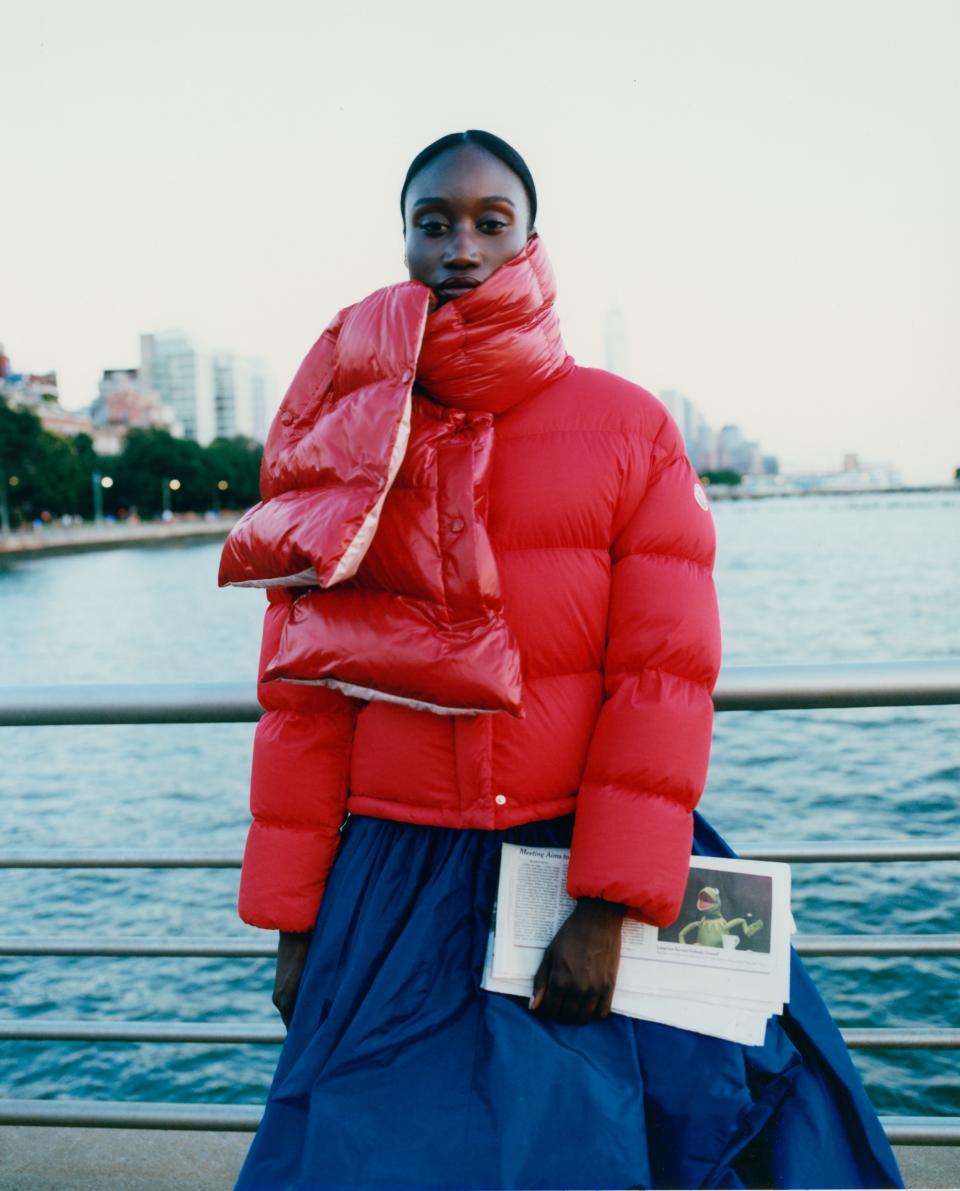Amy Sall, founder of Sunu journal, puts primary colors on full display, pairing her candy apple red <a rel="nofollow noopener" href="https://weallwear.moncler.com/" target="_blank" data-ylk="slk:Moncler Paeonia jacket;elm:context_link;itc:0;sec:content-canvas" class="link ">Moncler Paeonia jacket</a>, $1,590, with the <a rel="nofollow noopener" href="https://weallwear.moncler.com/" target="_blank" data-ylk="slk:Moncler scarf in nylon laque;elm:context_link;itc:0;sec:content-canvas" class="link ">Moncler scarf in nylon laque</a>, $470 and a billowy blue skirt.